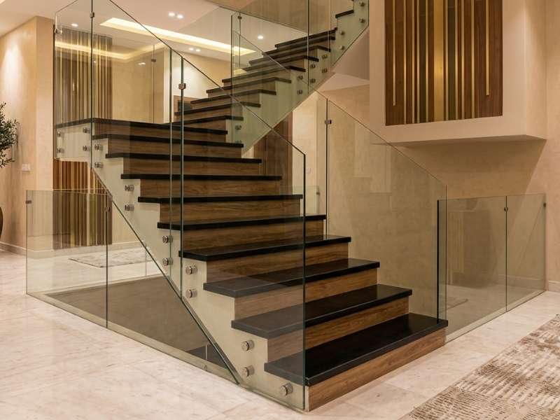 premium frameless glass railing for a luxury black marble staircase in a riyadh villa.